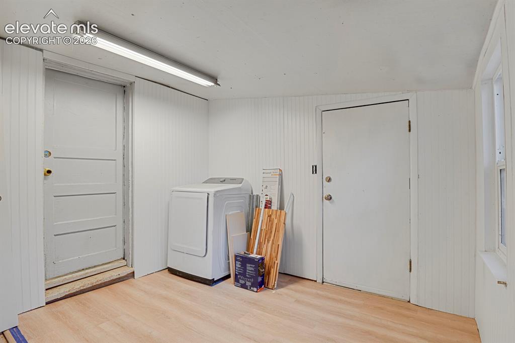 Image 36 of 39: Mud room with door to the backyard