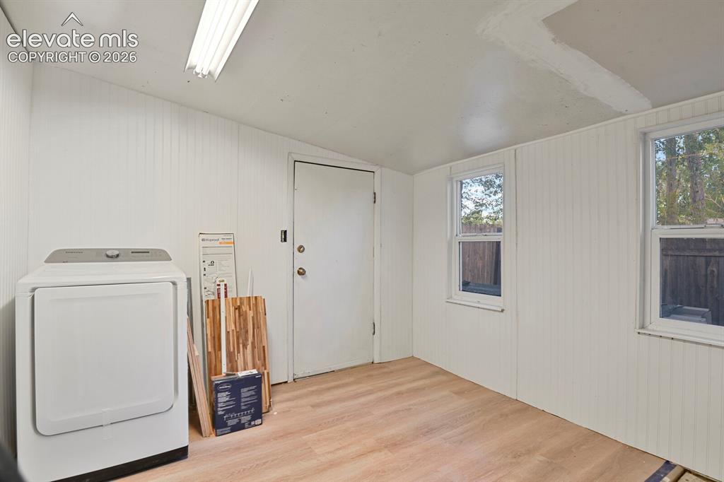 Image 37 of 39: Mud room with door to the backyard