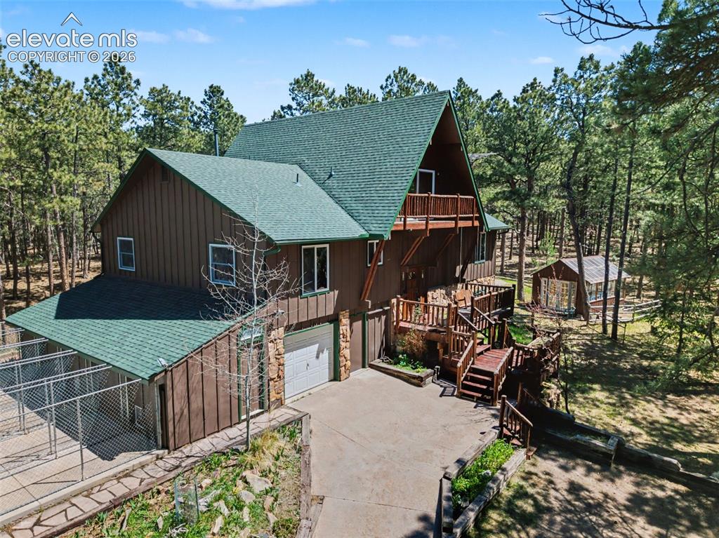 Image 1 of 50: Front of the home with the dog kennel