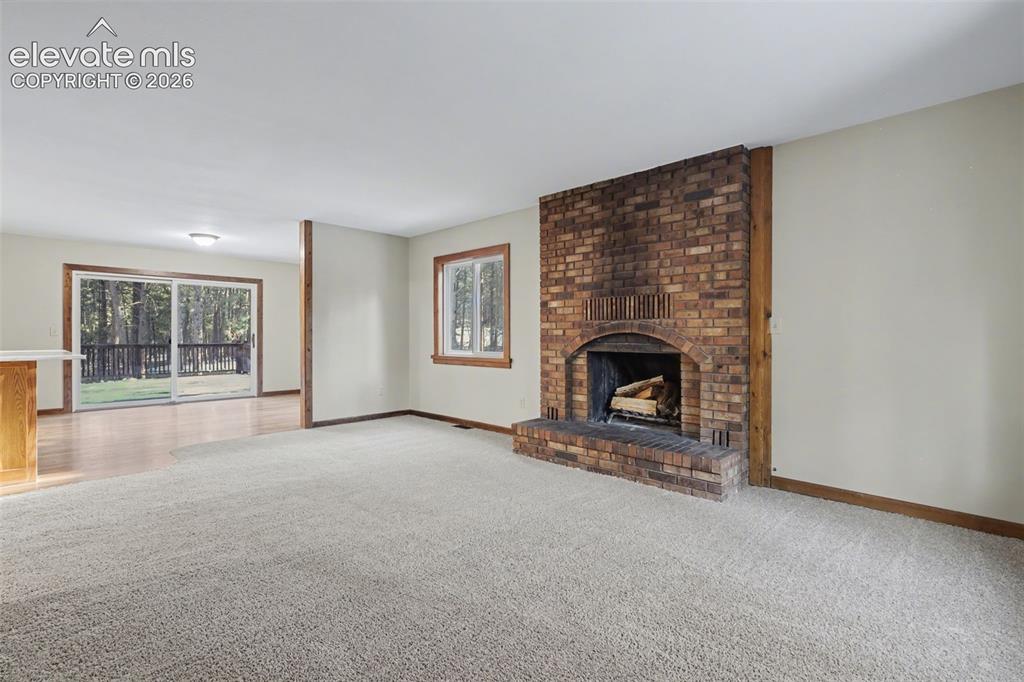 Image 12 of 50: Wood burning fireplace with a fan