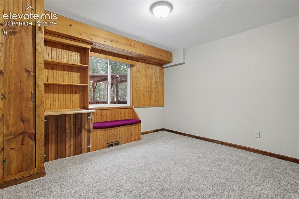 Image 14 of 50: Bedroom 1 with built ins