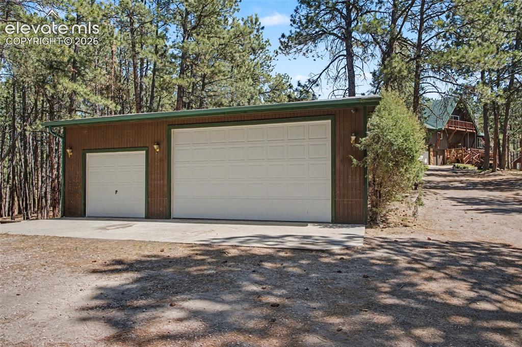 Image 43 of 50: 3 car garage with concrete floor, electric