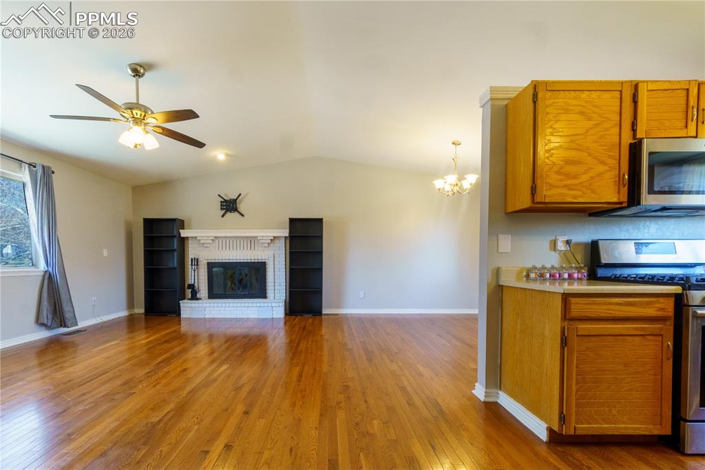 Image 5 of 25: With wood floors and fireplace