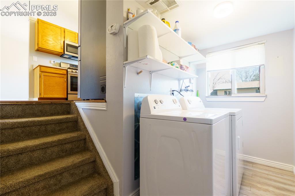 Image 9 of 25: Clothes washing area featuring laundry area, separate washer and dryer, vis