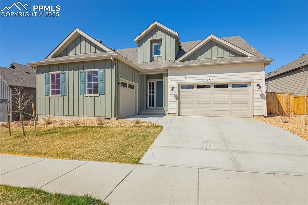 Image 2 of 47: View of front of home featuring board and batten siding, a garage, a shingl