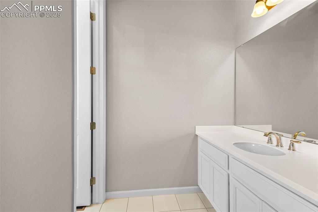 Image 21 of 47: Bathroom with vanity and tile patterned flooring