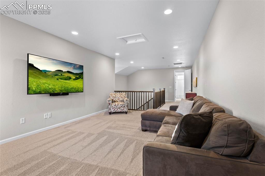 Image 27 of 47: Carpeted living room with recessed lighting and attic access