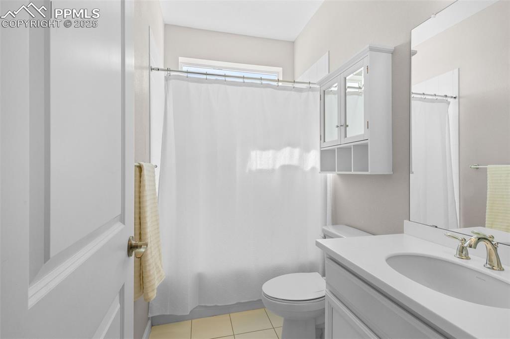 Image 29 of 47: Full bathroom with vanity, tile patterned flooring, and shower / bath combi