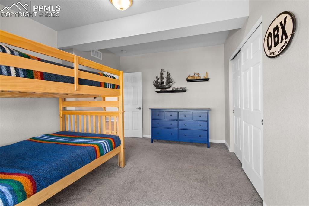 Image 35 of 47: Carpeted bedroom with a closet and baseboards