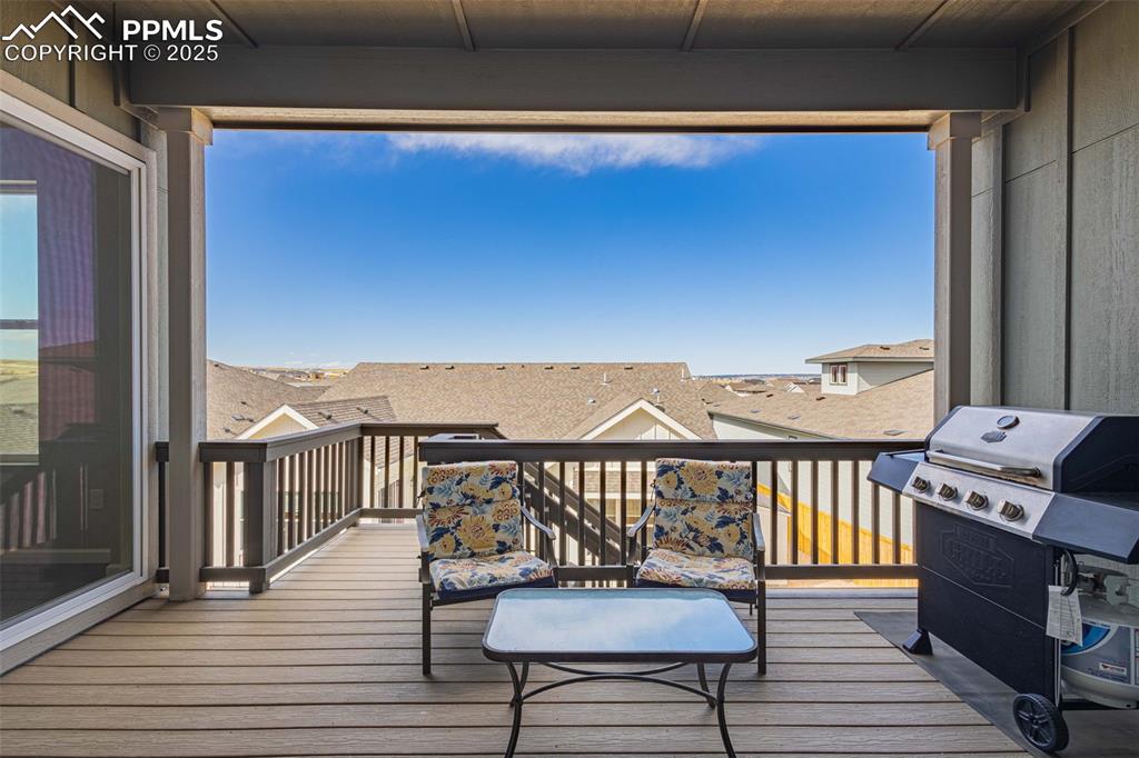 Image 36 of 47: Deck with a grill and a residential view