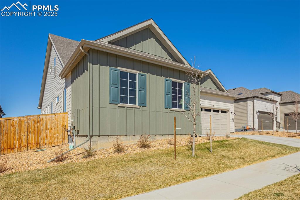 Image 38 of 47: View of front of home featuring board and batten siding, an attached garage
