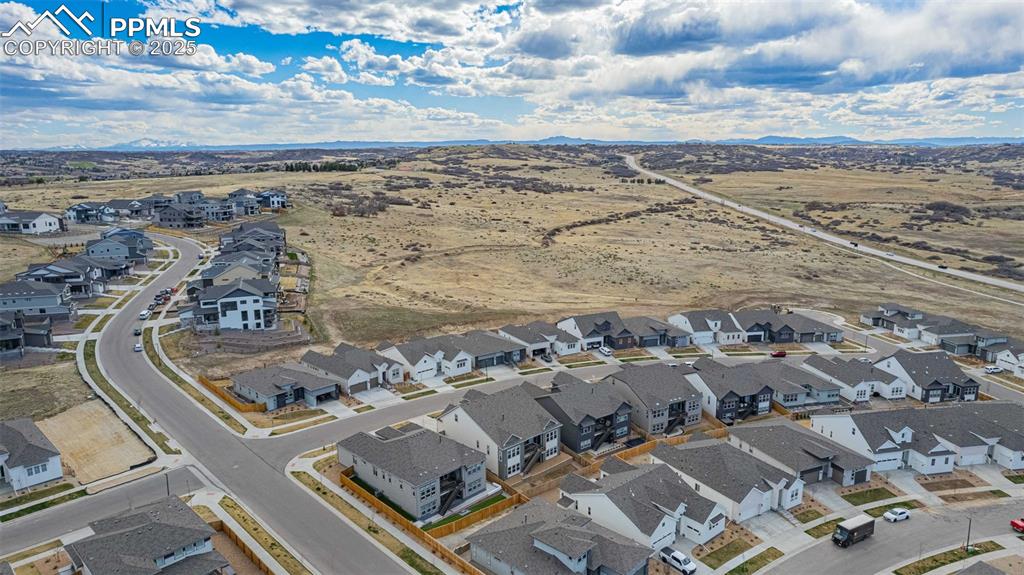 Image 45 of 47: Aerial perspective of suburban area with a mountainous background