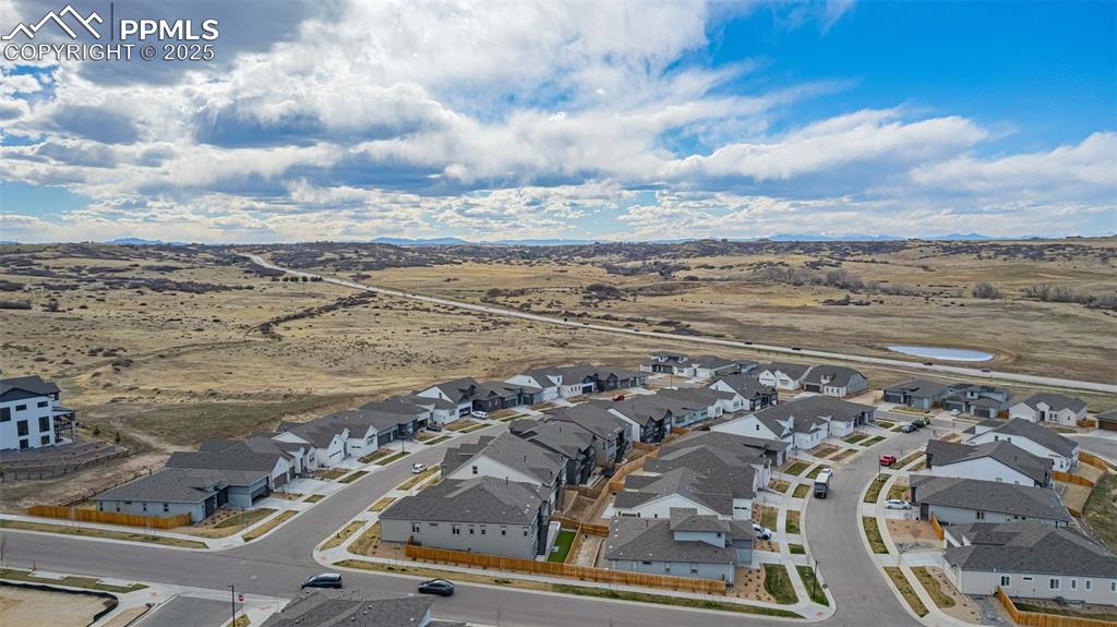 Image 46 of 47: Aerial view of residential area with a mountainous background