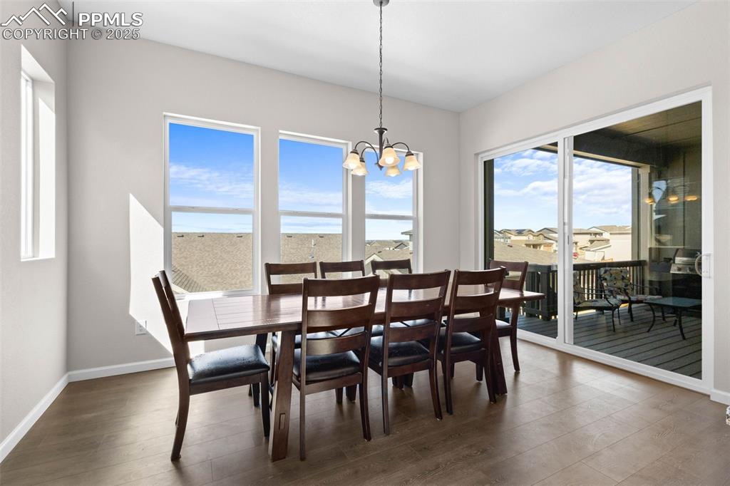 Image 8 of 47: Dining space featuring dark wood-style flooring, healthy amount of natural 