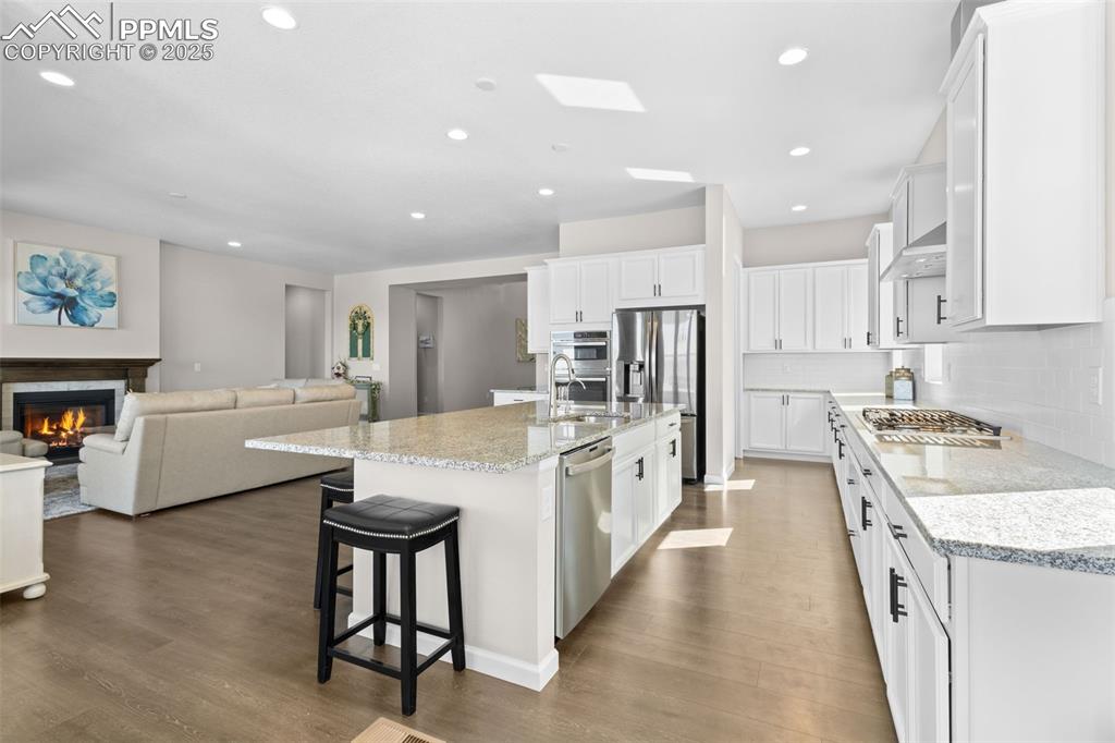 Image 9 of 47: Kitchen featuring stainless steel appliances, recessed lighting, white cabi