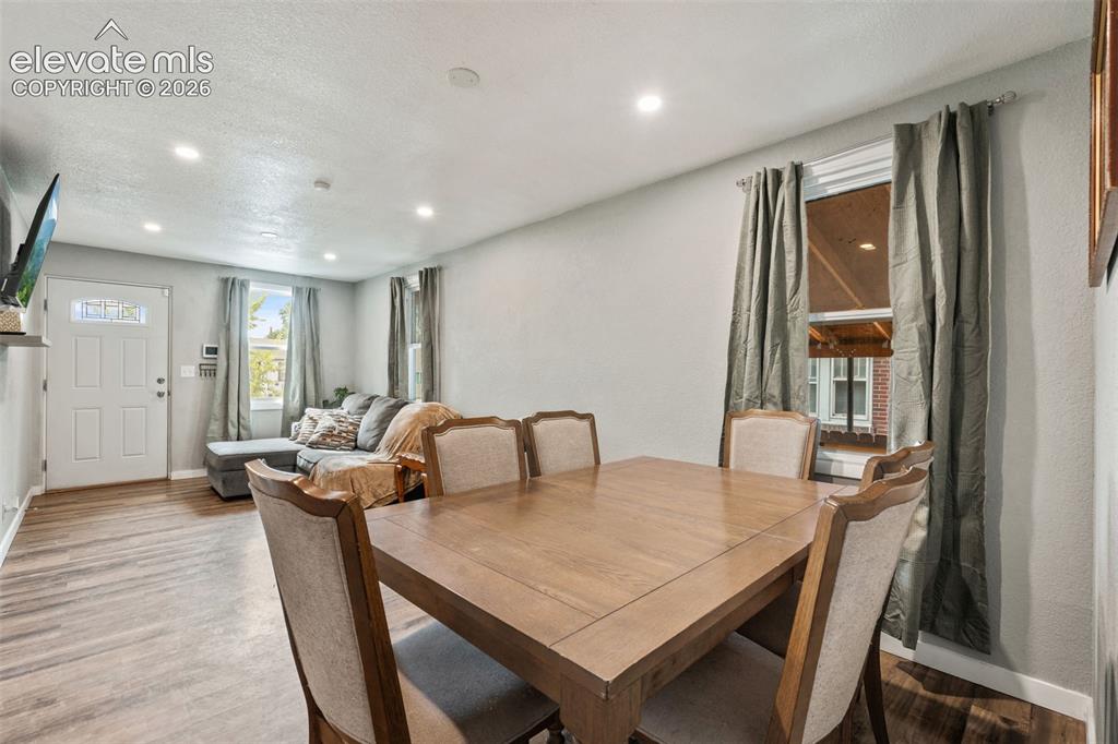 Image 14 of 50: Open-concept living area featuring recessed lighting, wood-finish flooring,