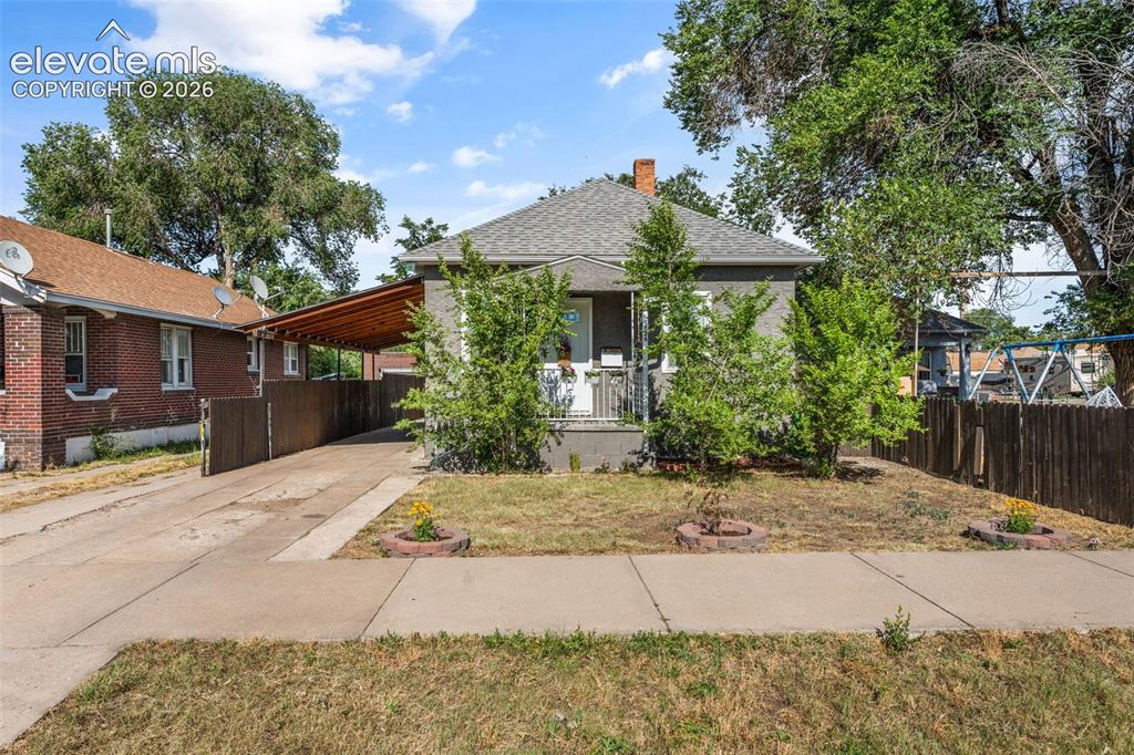 Image 4 of 50: Gray-hued exterior featuring a covered front porch, an extended driveway, a