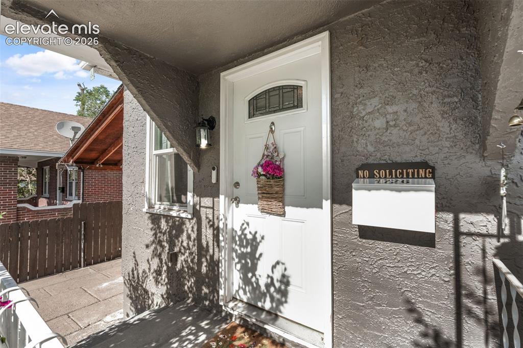 Image 8 of 50: Front entry featuring a white paneled door with an arched glass insert, tex