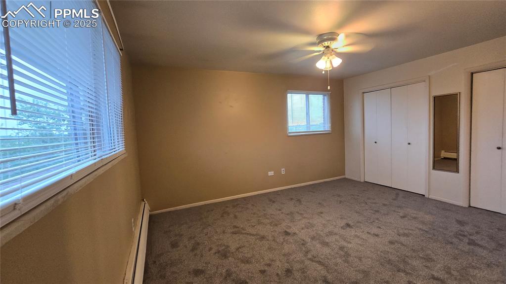 Image 4 of 18: Unfurnished bedroom featuring a baseboard radiator, carpet floors, ceiling
