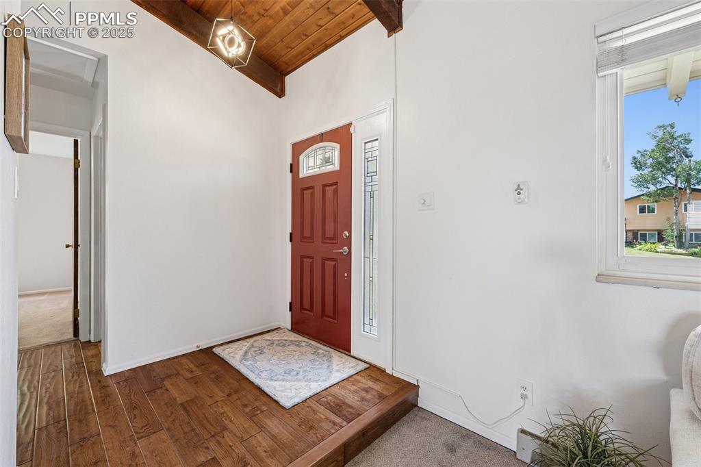 Image 14 of 34: Entryway with wooden ceiling and wood finished floors