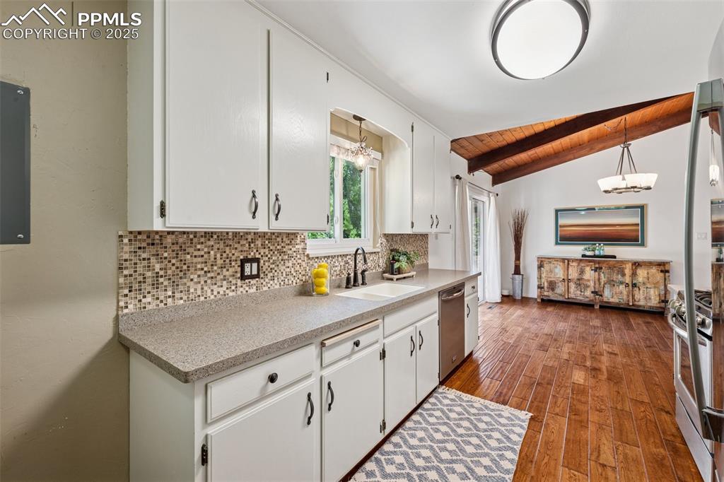 Image 26 of 34: Kitchen featuring tasteful backsplash, hardwood / wood-style flooring, wood