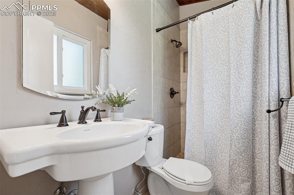 Image 30 of 34: 3/4 bath featuring a shower with curtain