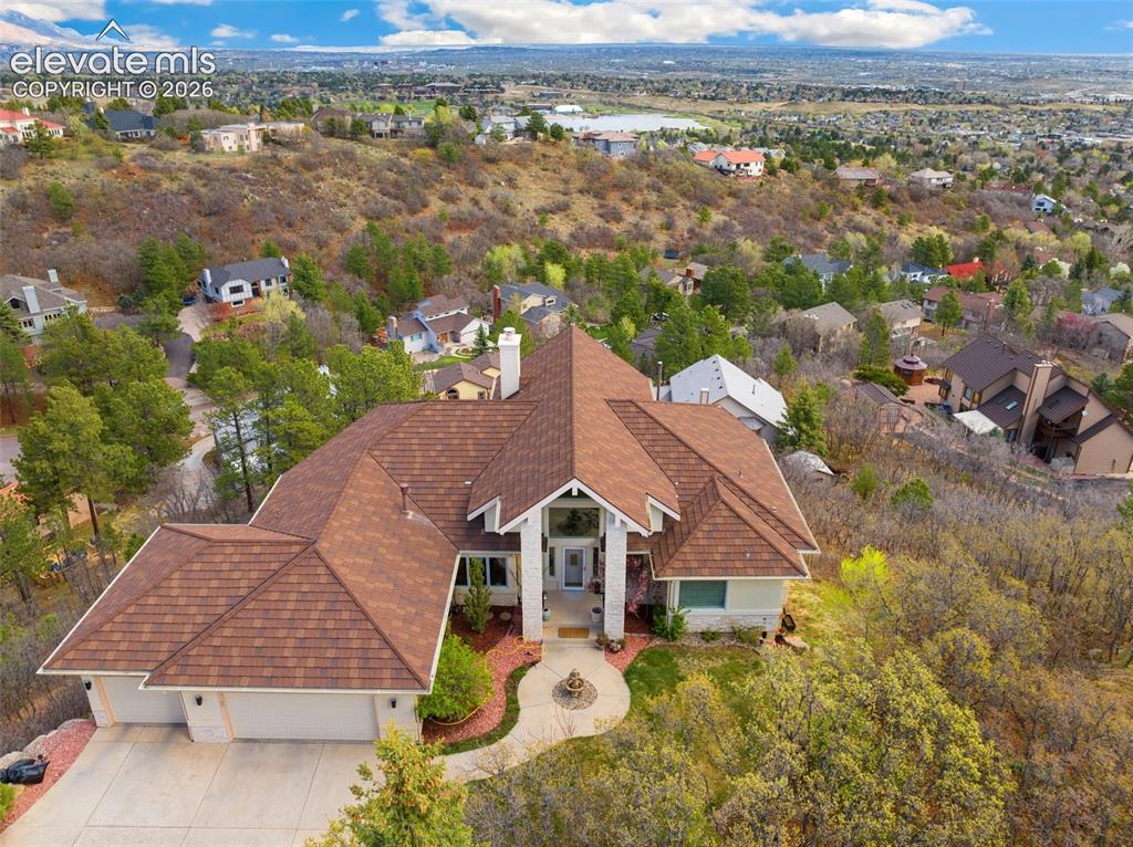Image 2 of 50: Expansive property featuring a multi-gabled roof, a two-car garage, and a s