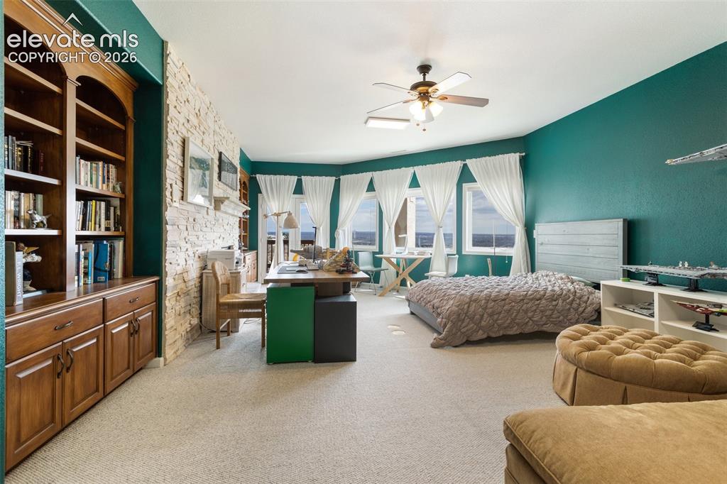Image 27 of 50: Spacious room featuring a bay window with multiple panes, a built-in wooden