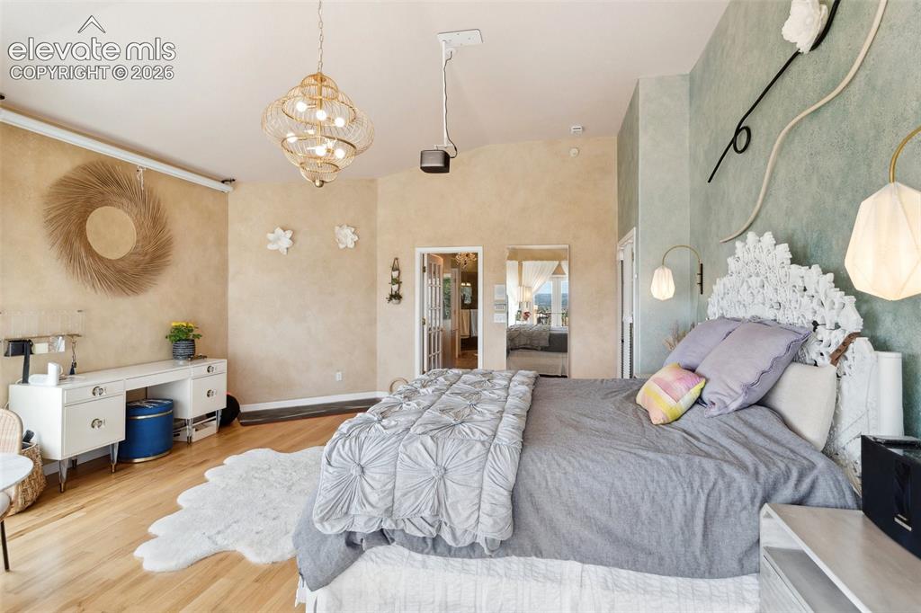 Image 37 of 50: Spacious room featuring vaulted ceilings, light wood-finish flooring, two d