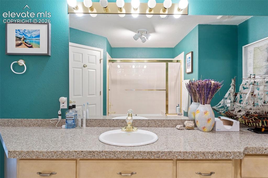 Image 39 of 50: Spacious vanity featuring a built-in sink and ample counter space
