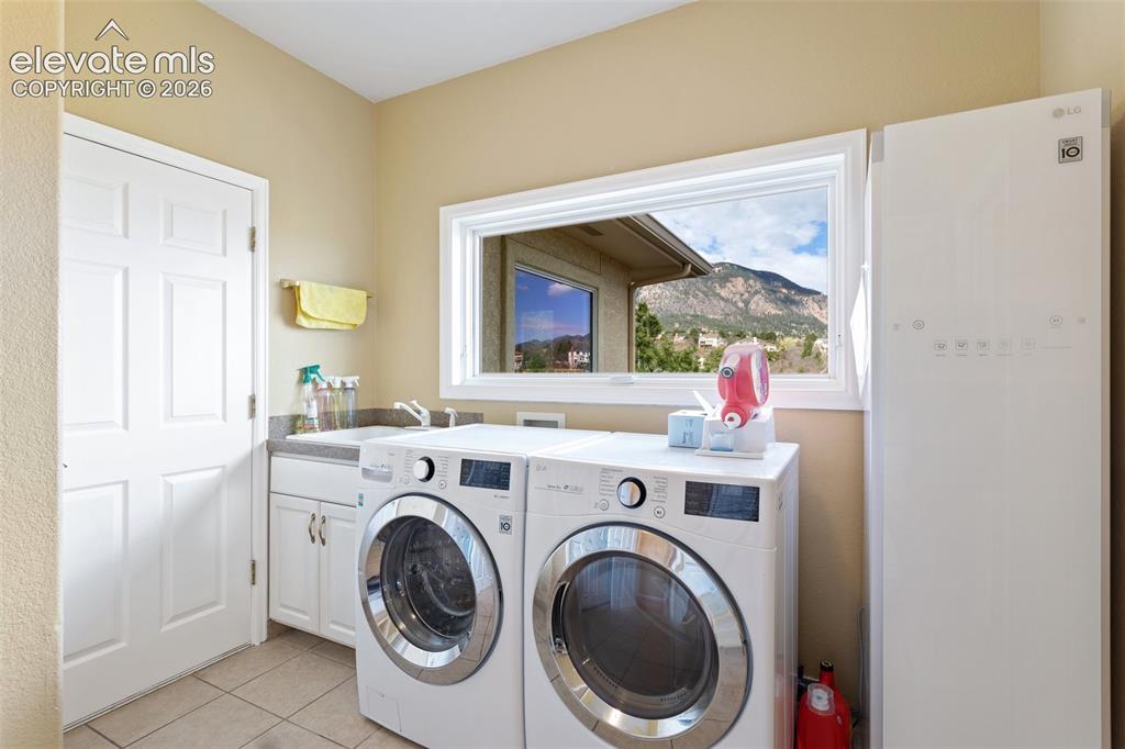 Image 45 of 50: Laundry area with a mountain backdrop visible through the window