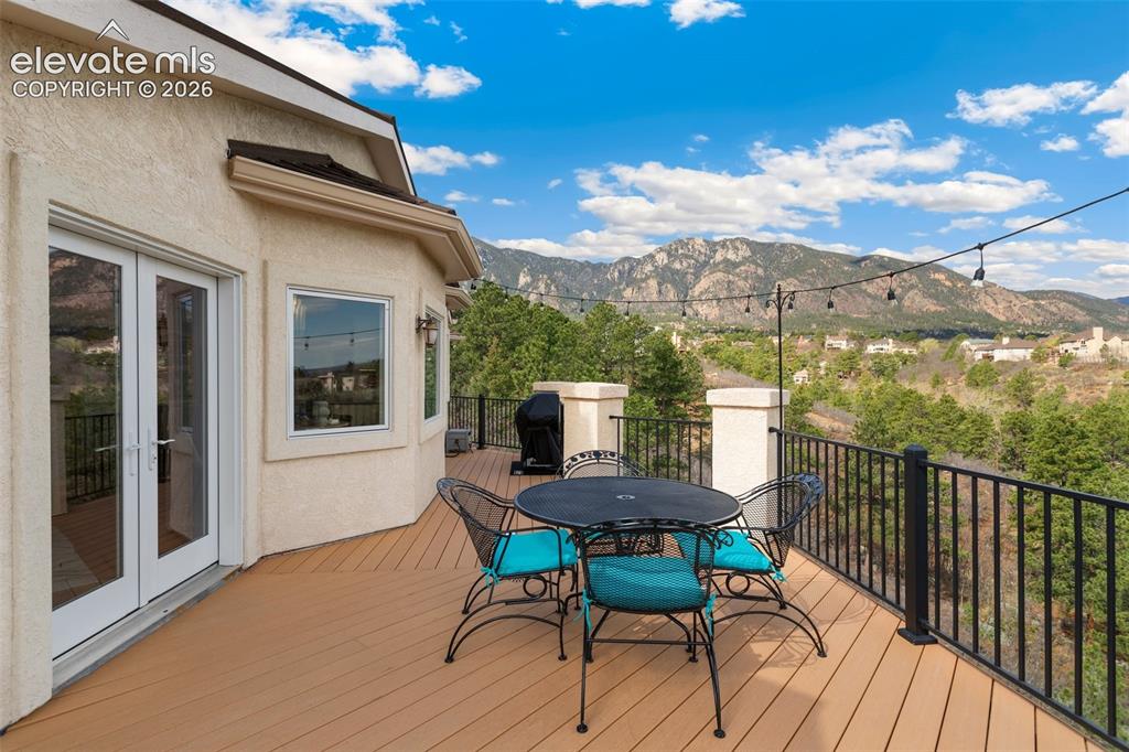 Image 47 of 50: Expansive outdoor deck featuring composite decking, black metal railing, an