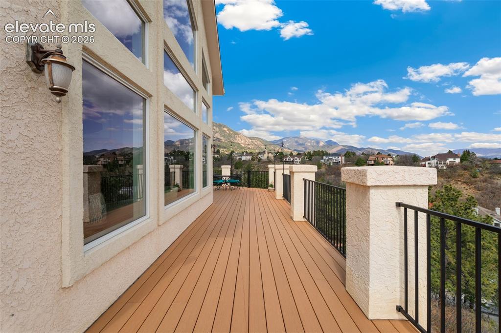 Image 49 of 50: Expansive outdoor deck featuring wood-finish flooring, stucco exterior, and