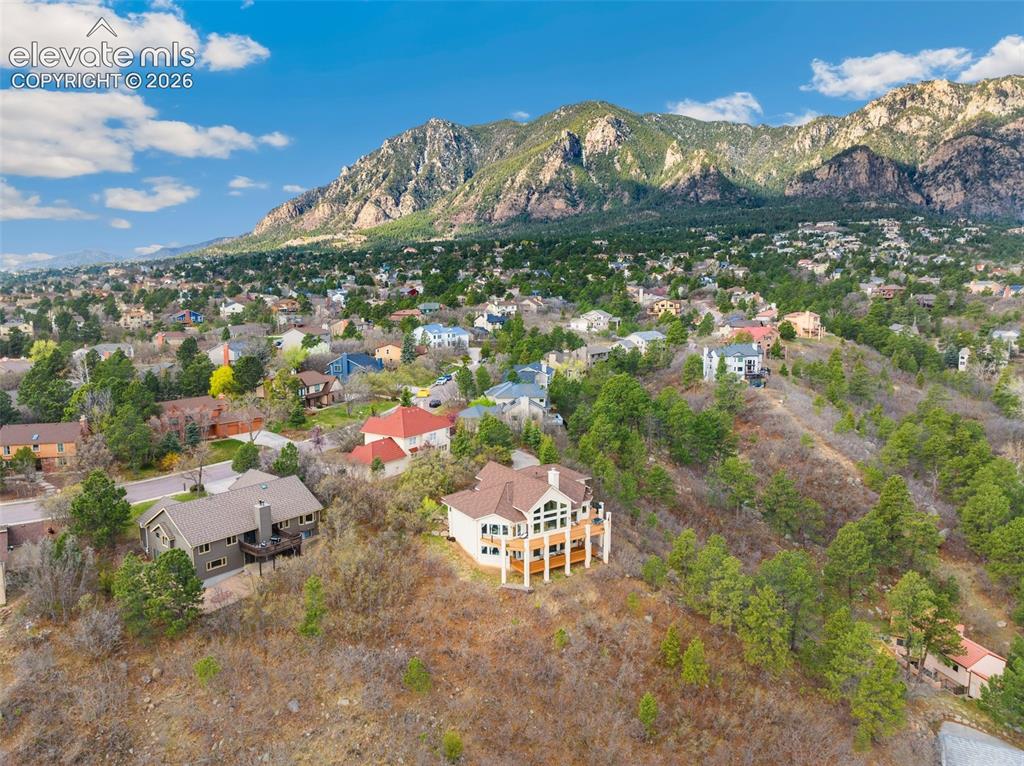 Image 7 of 50: Expansive mountain residential area featuring numerous homes nestled among