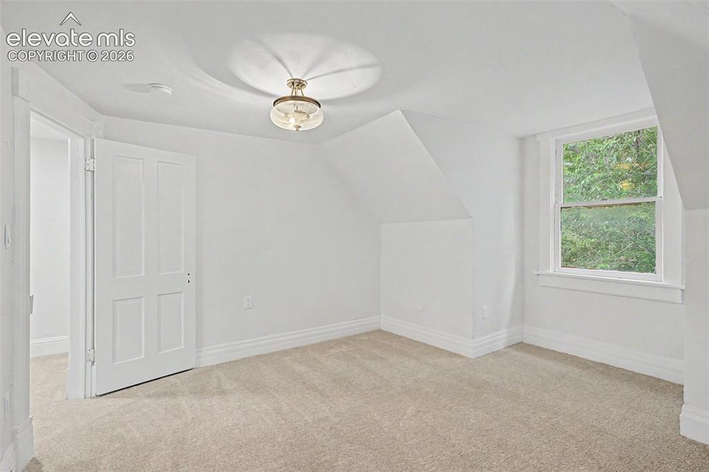 Image 30 of 38: Carpeted interior space with a window offering natural light, a four-panel