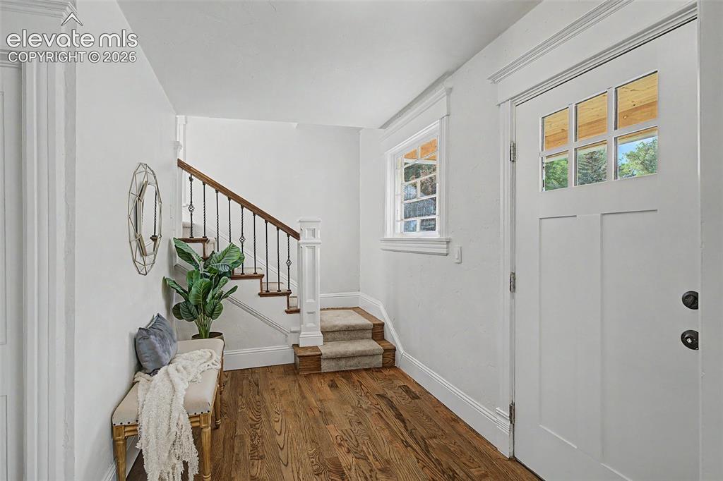 Image 4 of 38: Entryway featuring a Craftsman-style door with multipane windows, a stairca