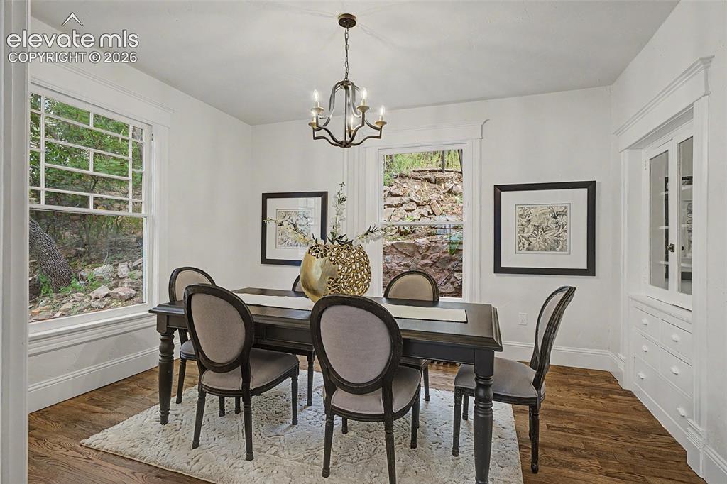 Image 8 of 38: Dining area featuring wood-finish flooring, white walls, and a built-in chi