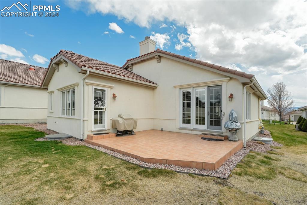 Image 36 of 40: Rear view of property with a patio and a lawn