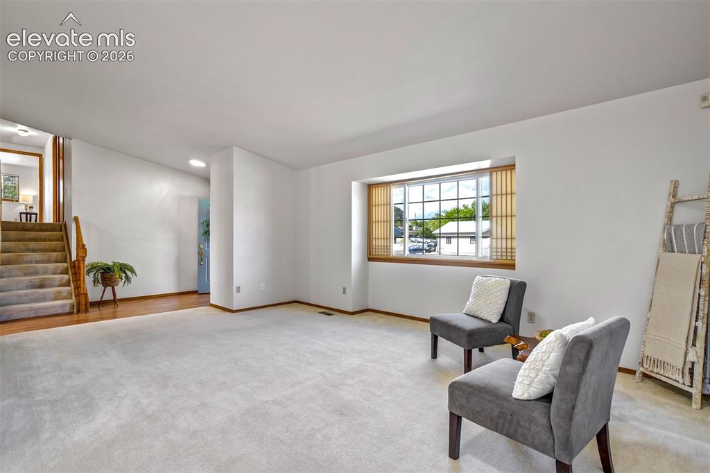 Image 10 of 50: Enjoy a living room off front door