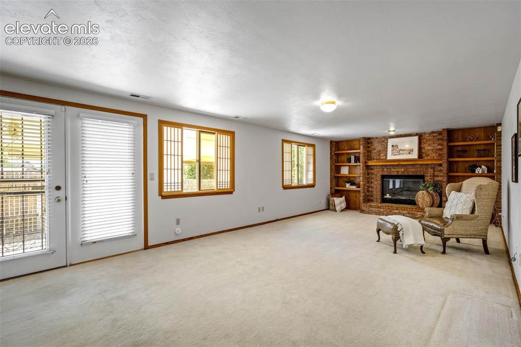 Image 19 of 50: Inviting family room opens to back yard