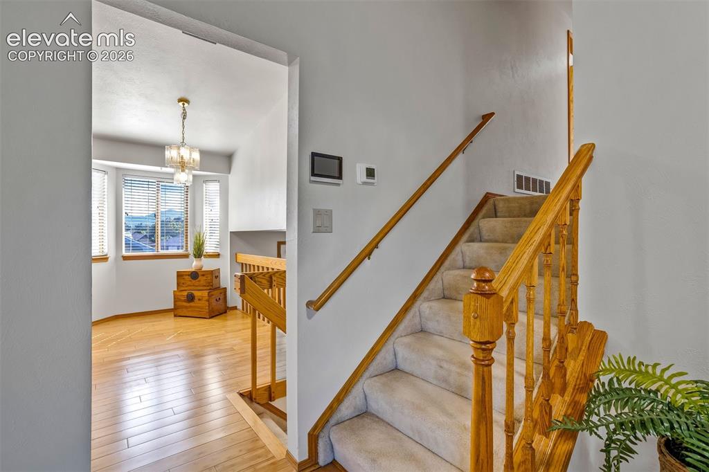 Image 26 of 50: Stairs to upper level with bedrooms