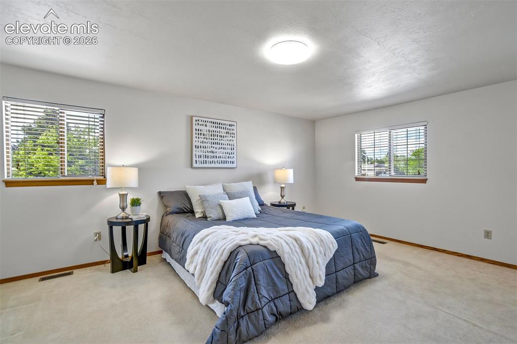 Image 27 of 50: Gorgeous natural light in primary bedroom
