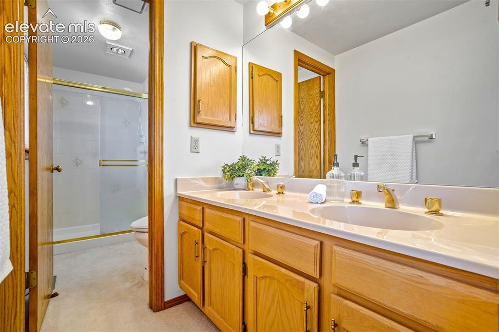 Image 30 of 50: Double vanity and a laundry chute!