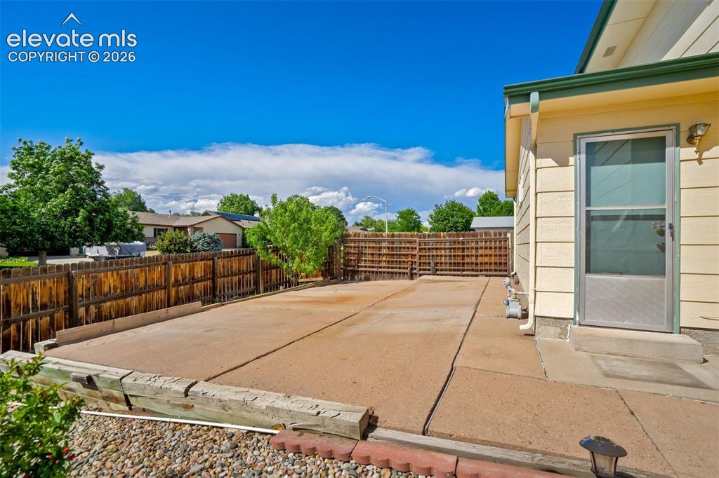 Image 45 of 50: Side yard with another slab provides so many options for use