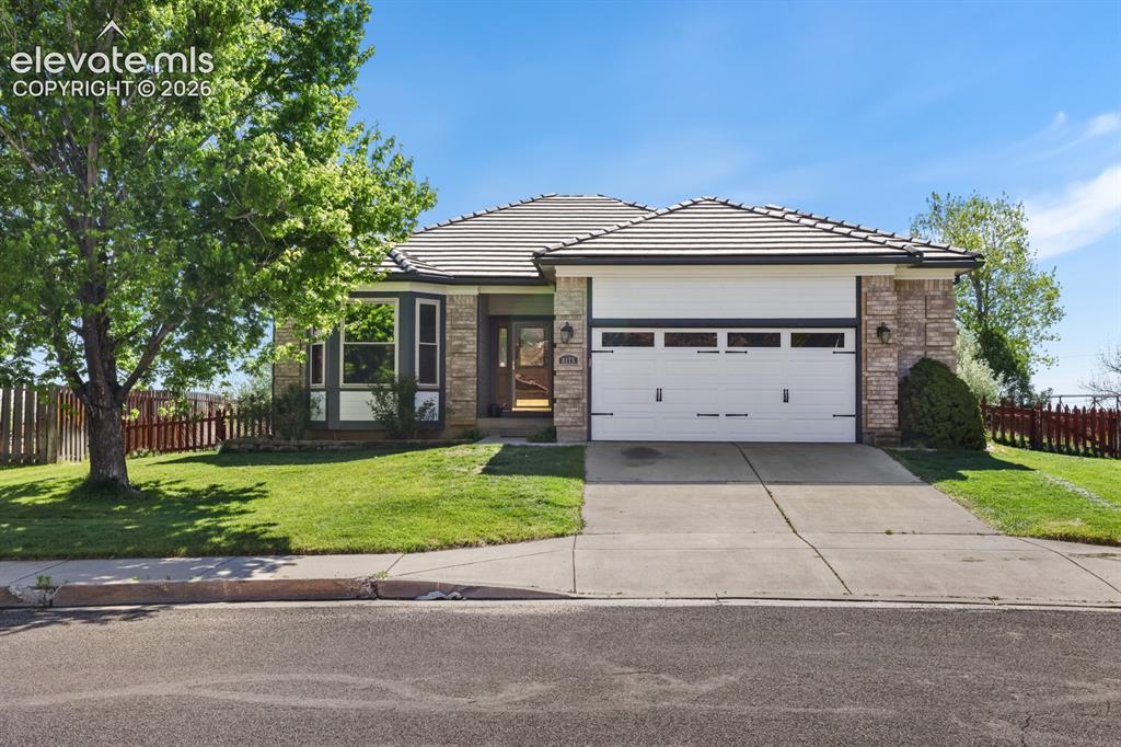 Image 1 of 37: Ranch-style residence featuring a tile roof and a two-car garage