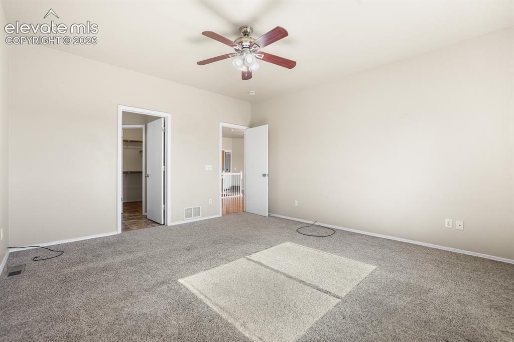 Image 12 of 37: Spacious room featuring neutral painted walls, gray carpeting, a multi-spee