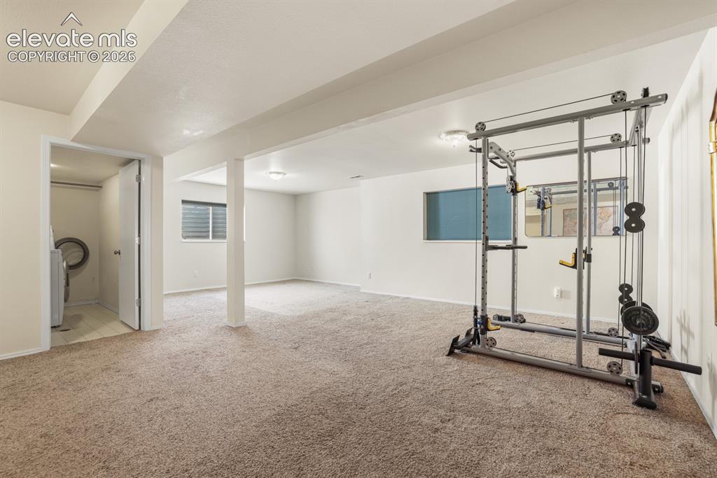 Image 19 of 37: Expansive finished basement featuring neutral carpeting, recessed lighting,