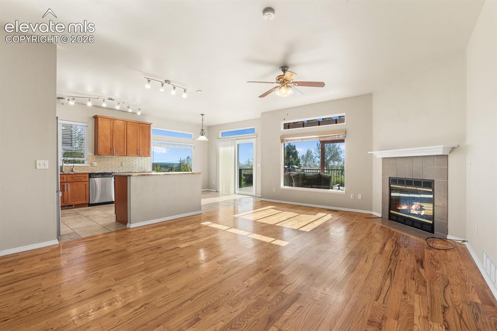 Image 6 of 37: Open-concept living area with polished wood-finish flooring