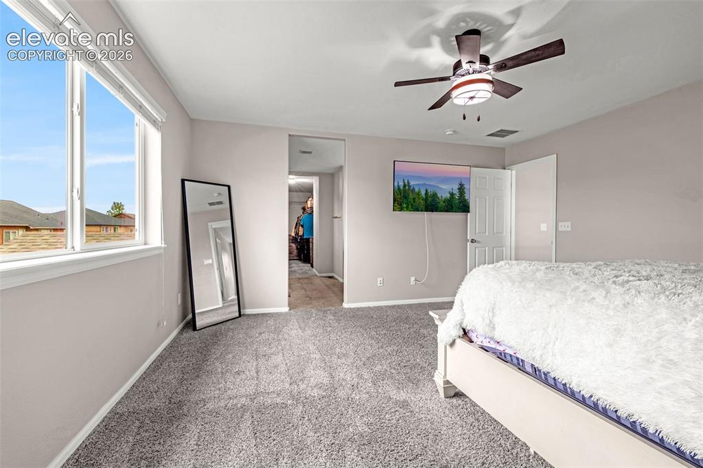 Image 19 of 49: Neutral-toned interior room with gray carpet and white trim