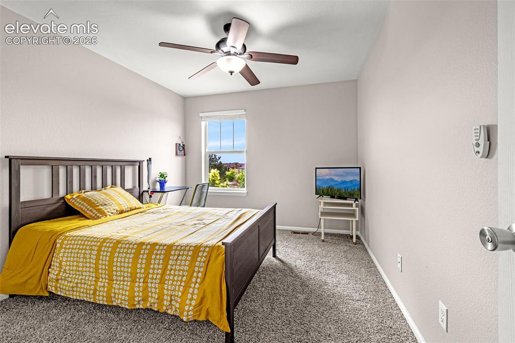 Image 24 of 49: Bright room featuring light-toned walls, a window with natural light, and a